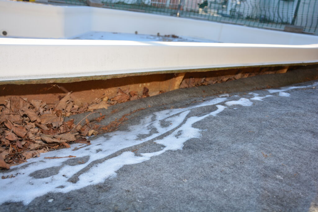 Vertical displacement of an in‑ground pool caused by hydrostatic pressures and freeze–thaw cycles.